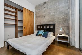San Francisco apartment for rent - a bedroom with a bed and a wall with a wooden closet