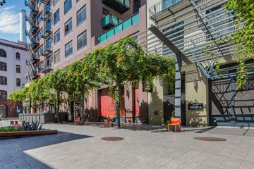 San Francisco apartment for rent - a courtyard with trees and a building with a red door