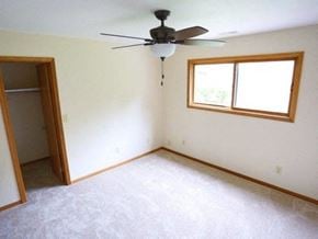 Rantoul apartment for rent - an empty living room with a ceiling fan and a closet