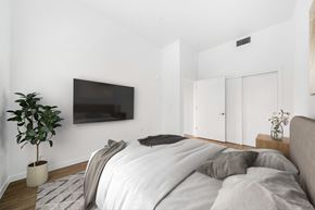 Sacramento apartment for rent - a bedroom with a bed and a tv on the wall