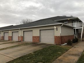 Rantoul apartment for rent - a house with three garage doors and a balcony