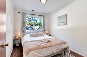Ferndale apartment for rent - A bedroom with a bed, nightstand, and window.