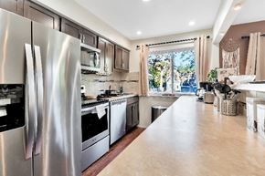 Ferndale apartment for rent - A kitchen with a large refrigerator and stainless steel appliances.