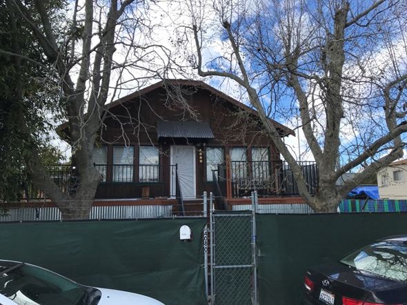 Sacramento apartment for rent - a house with a fence and cars in front of it