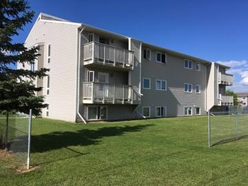 Prince Albert house for rent - the back of an apartment building with balconies and a lawn