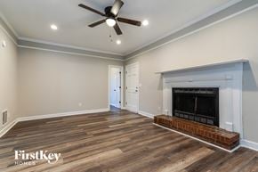 Snellville house for rent - a living room with a fireplace and a ceiling fan