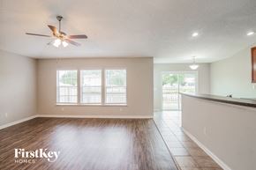 Jacksonville house for rent - A spacious room with a ceiling fan and wooden flooring.