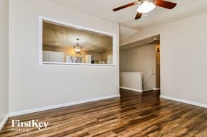 O'fallon house for rent - a living room with a large window and a ceiling fan