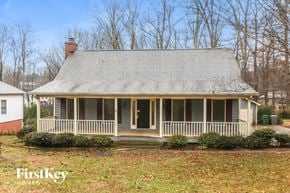 Charlotte house for rent - a white house with a porch and a gray roof