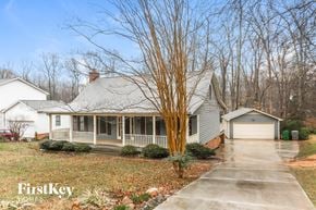 Charlotte house for rent - a white house with a porch and a tree