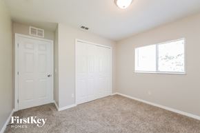 Lehigh Acres house for rent - an empty bedroom with two doors and a window
