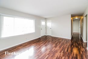Trenton house for rent - A room with wooden floors and white walls.