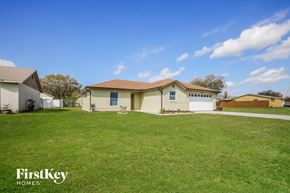 Poinciana house for rent - a home with a large lawn and a garage