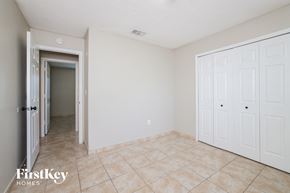 Poinciana house for rent - a bedroom with two closets and a tiled floor