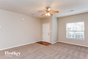 Fuquay-Varina house for rent - A room with a carpeted floor and a ceiling fan.