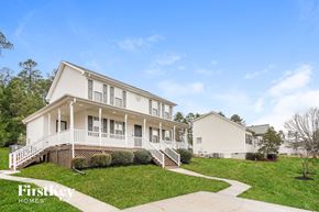 Durham house for rent - A white two-story house with a porch and a tree in front.