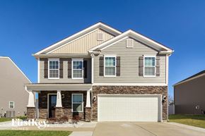 Charlotte house for rent - A two-story house with a garage is showcased in the image.