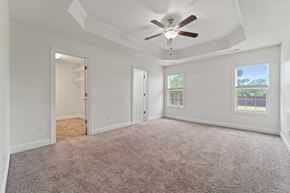 Sneads Ferry house for rent - A spacious room with a ceiling fan and carpeted floor.