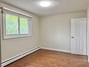 Guelph apartment for rent - A room with a white door, a window, and a light switch on the wall.