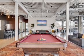 Minneapolis apartment for rent - a pool table in the lobby of an office with a bar