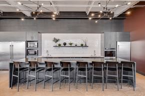 Minneapolis apartment for rent - a kitchen with a large island and chairs in front of a refrigerator