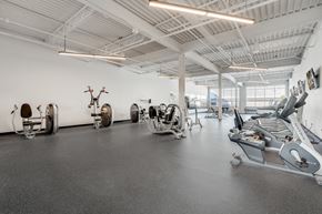 Minneapolis apartment for rent - a gym with cardio equipment and weights on the floor