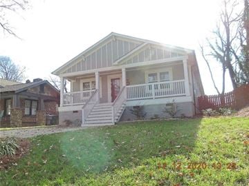 Charlotte house for rent - a white house with a porch and a lawn