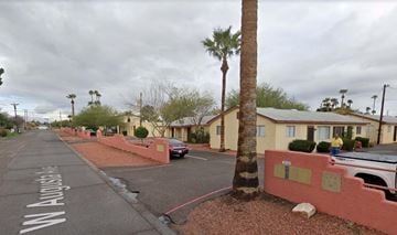 Phoenix apartment for rent - a street with houses and palm trees on the side of it