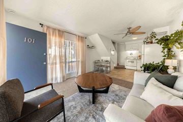 Goleta apartment for rent - A living room with a brown chair and a wooden coffee table.