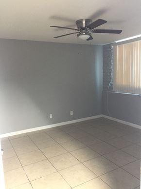Phoenix apartment for rent - an empty room with a ceiling fan and a tiled floor