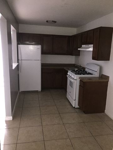 Phoenix apartment for rent - an empty kitchen with a white stove and refrigerator