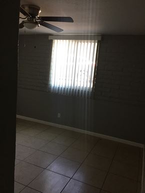 Phoenix apartment for rent - an empty room with a window and a ceiling fan