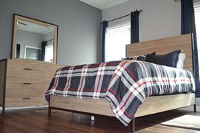 Bay City apartment for rent - a bedroom with a bed and a dresser and a mirror
