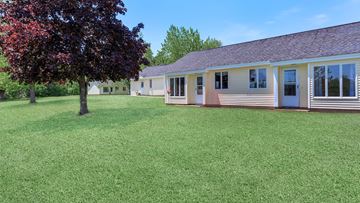 Cherryfield apartment for rent - a white house with a yard and a tree