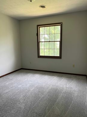 Hartville apartment for rent - A room with a window and carpeted floor.