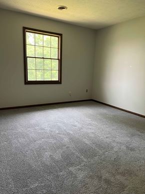 Hartville apartment for rent - A room with a window and carpeted floor.