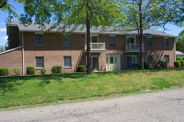 Hartville apartment for rent - A large brick building with a tree in front of it.