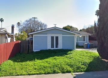 Vallejo apartment for rent - a small white house with a yard and a fence