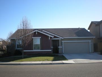 Newman house for rent - the front of a house with a driveway and a garage door