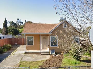 Vallejo apartment for rent - a small brown house with a yard and a fence
