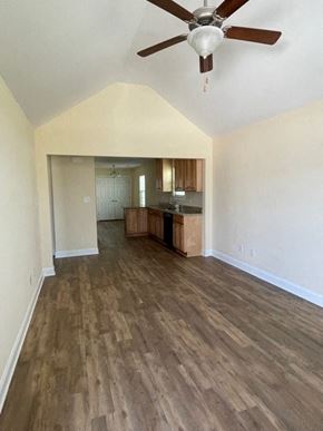Youngsville apartment for rent - A room with a ceiling fan and wooden flooring.