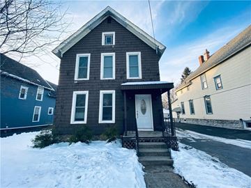 Watertown house for rent - a brown house with a white door in the snow