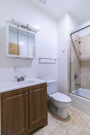 Berkeley apartment for rent - A white sink with a wooden cabinet below it.