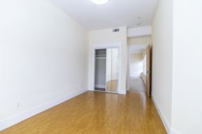 Berkeley apartment for rent - A room with wooden floors and white walls.