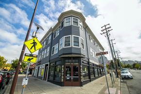 Berkeley apartment for rent - A street view of 2597 Telegraph with a pedestrian crossing sign.