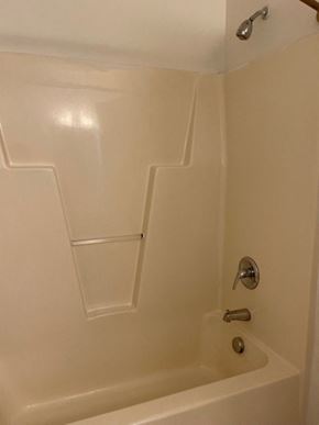 Youngsville apartment for rent - A white bathtub with a silver faucet and a silver shower head.