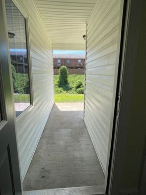Youngsville apartment for rent - A view from the inside of a house looking out to a green lawn and a building in the distance.
