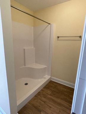 Youngsville apartment for rent - A white bathtub with a shower head and a white towel bar.