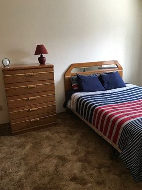 Nikiski apartment for rent - a bedroom with a bed and a dresser