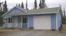 Kenai house for rent - A blue house with a white garage door.